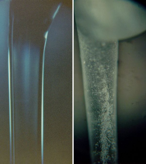 A drawn ZBLAN fiber, clear on one side and crystallized/cloudy on the other.